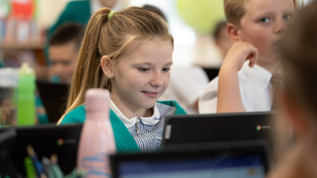 A female student using a Chromebook in a lesson