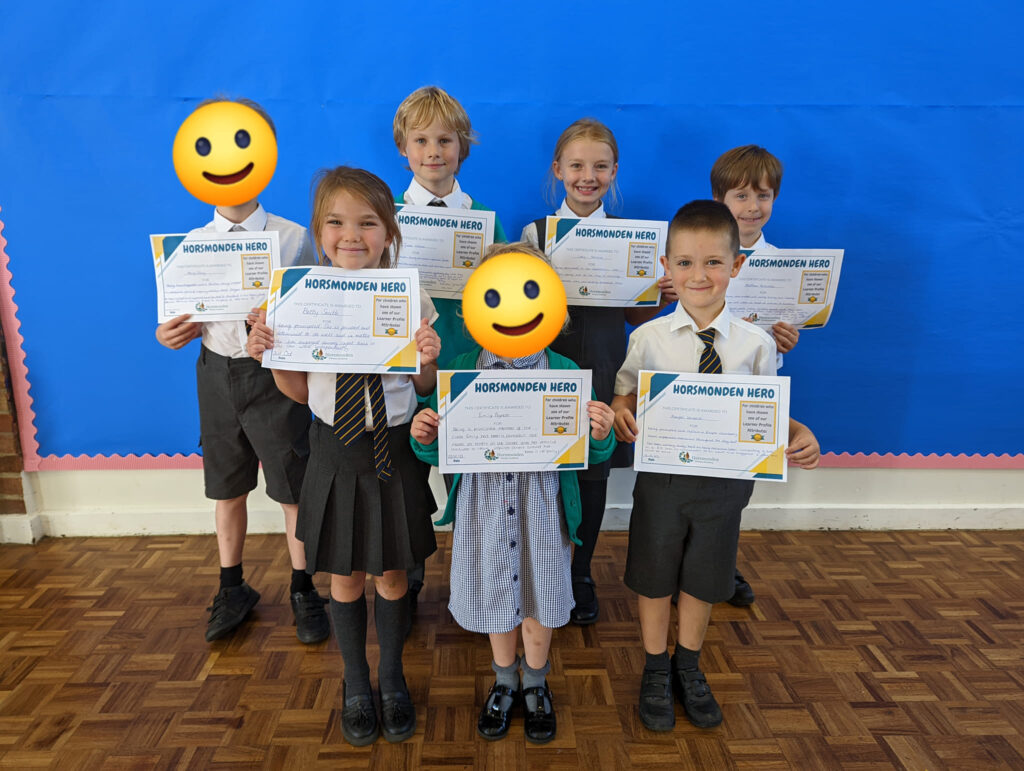 Photo showing winners of the Horsmonden Hero award holding up their certificates and smiling for the camera.