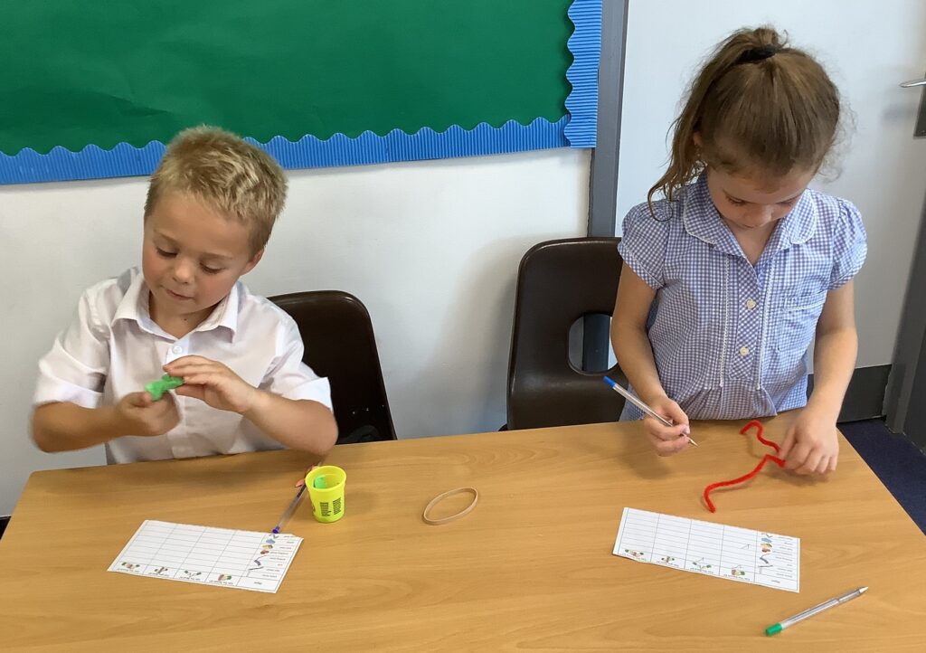Children in Year 2 are seen experimenting with different materials to see which ones can change shape and why.