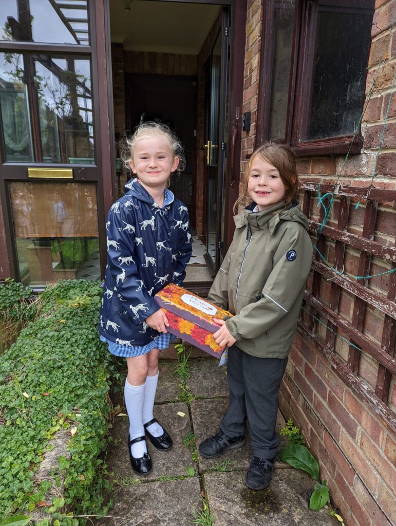 2 children holding a harvest box