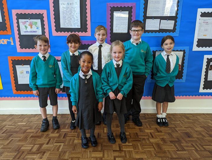 Photo showing winners of the Horsmonden Hero award holding up their certificates and smiling for the camera.