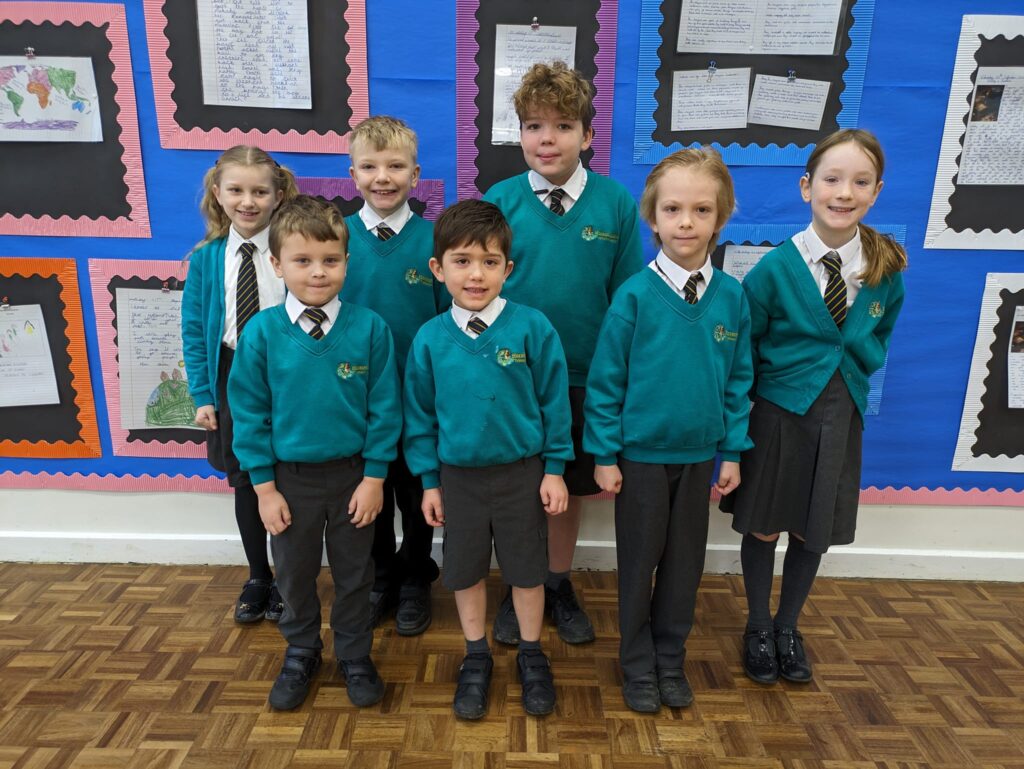 Photo showing winners of the Horsmonden Hero award holding up their certificates and smiling for the camera.