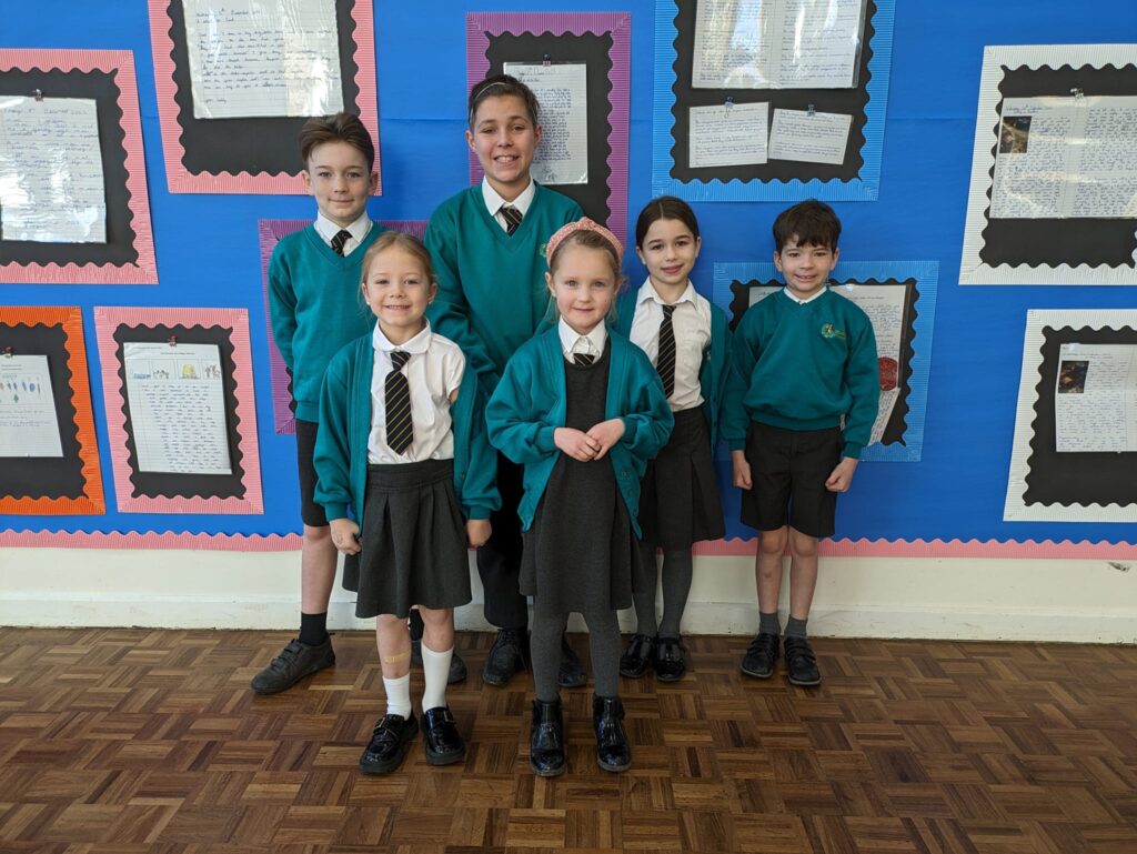 Photo showing winners of the Horsmonden Hero award holding up their certificates and smiling for the camera.