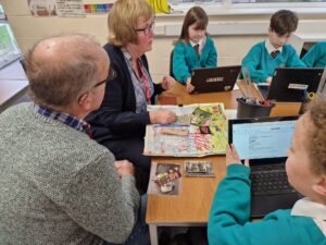 Members of the Horsmonden Nostalgia Society are pictured sharing their collection of WWII memorabilia, as well as their perspectives on the war with some Horsmonden students.