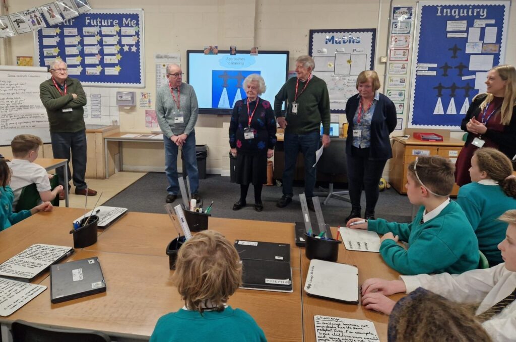 Members of the Horsmonden Nostalgia Society are pictured sharing their collection of WWII memorabilia, as well as their perspectives on the war with some Horsmonden students.