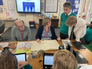 Members of the Horsmonden Nostalgia Society are pictured sharing their collection of WWII memorabilia, as well as their perspectives on the war with some Horsmonden students.