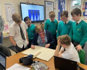 Members of the Horsmonden Nostalgia Society are pictured sharing their collection of WWII memorabilia, as well as their perspectives on the war with some Horsmonden students.