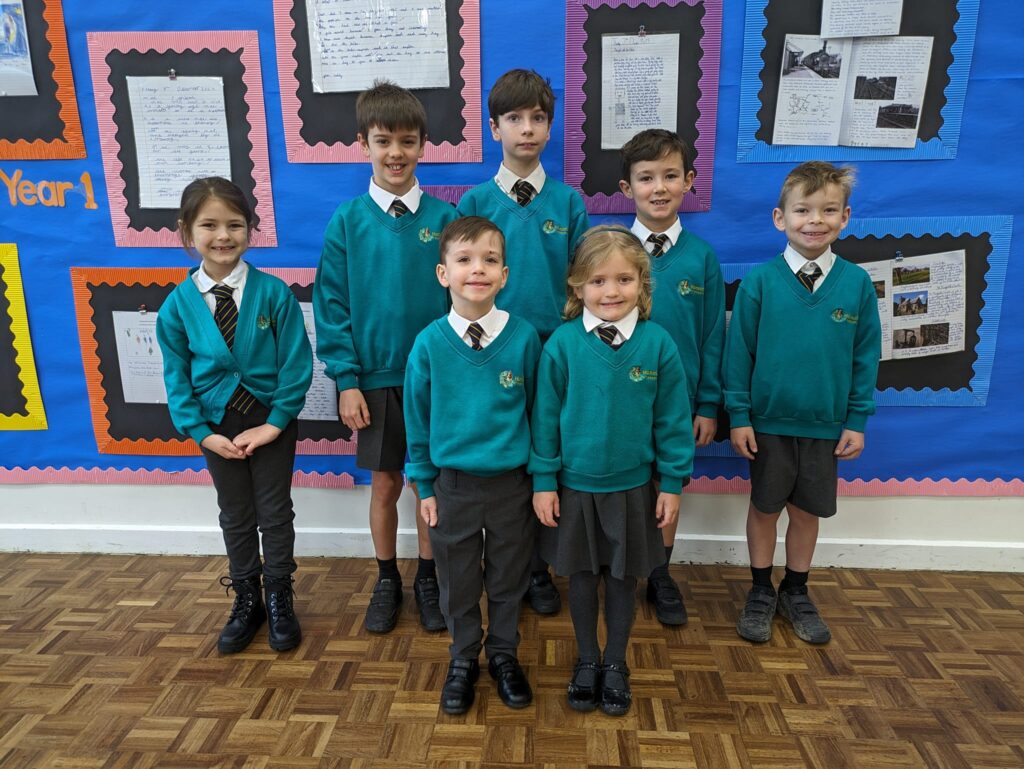 Photo showing winners of the Horsmonden Hero award holding up their certificates and smiling for the camera.