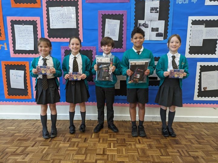 Photo showing winners of the Horsmonden Hero award holding up their certificates and smiling for the camera.