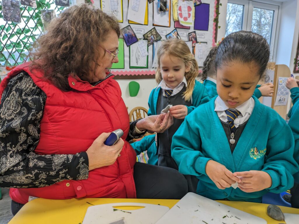 A student at a table working with a teacher