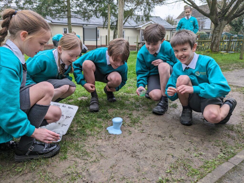Students crouched outside watching their 'potion'