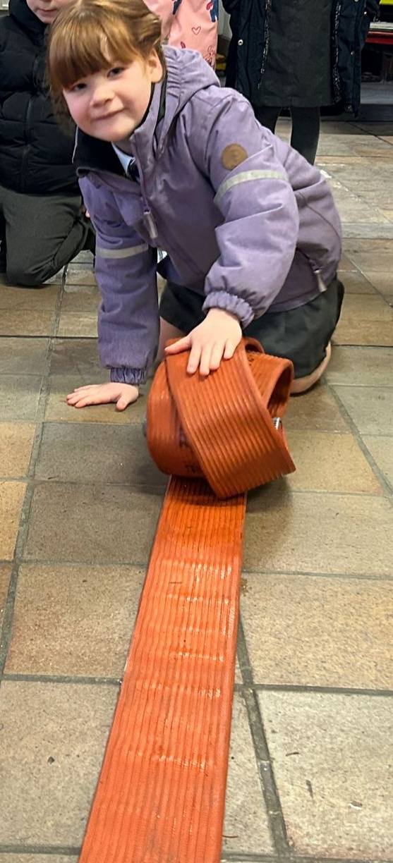 A child pushing out a fire hose
